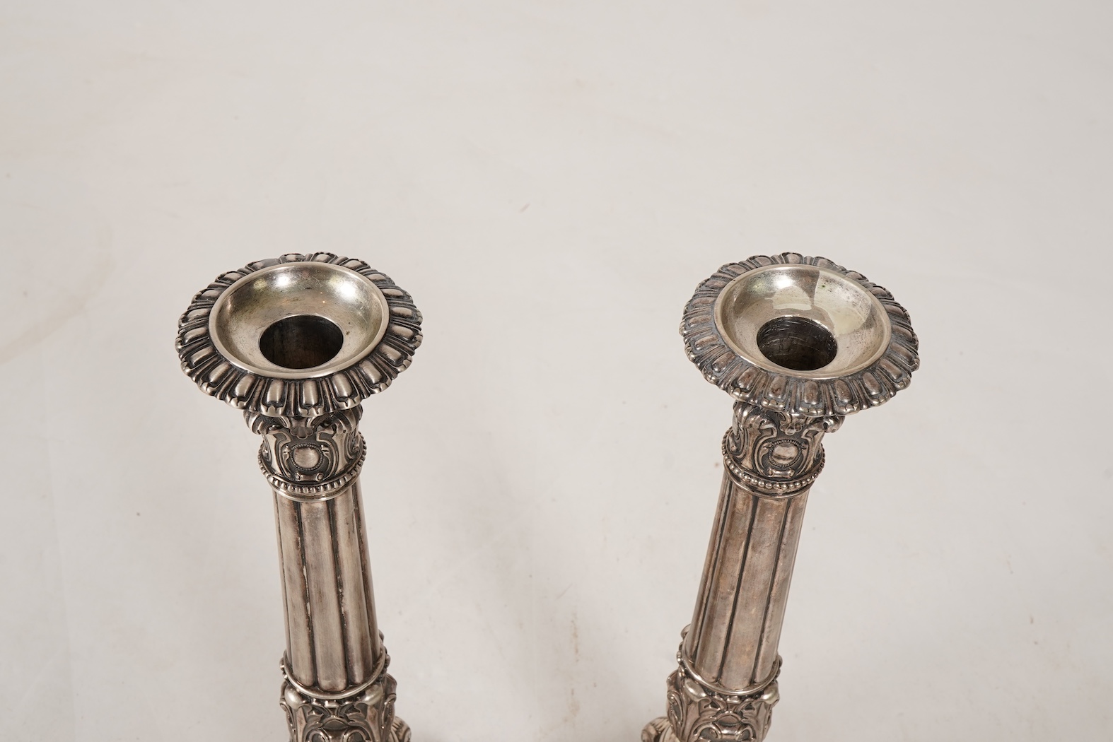A pair of late 18th/early 19th century German white metal candlesticks, maker's mark W.C.H & S